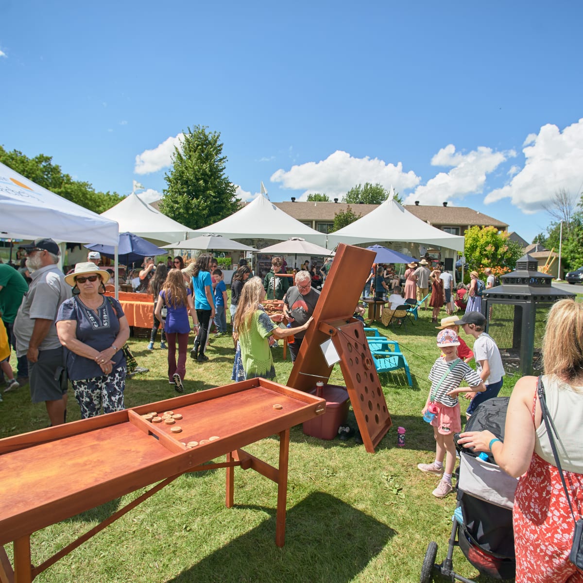 Giant wood games and tents outside.