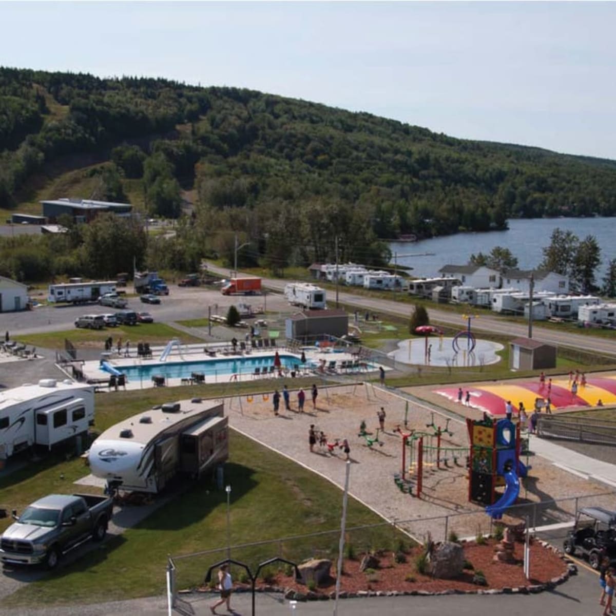 Pool and travel trailers at Camping Bas-St-Laurent.