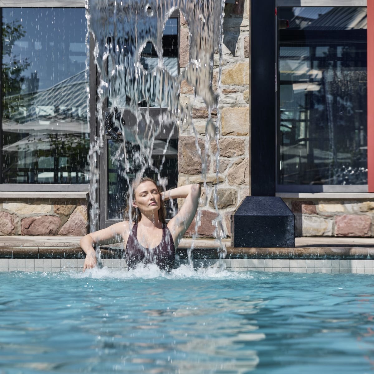 Woman in the outdoor pool at Fairmont Tremblant.
