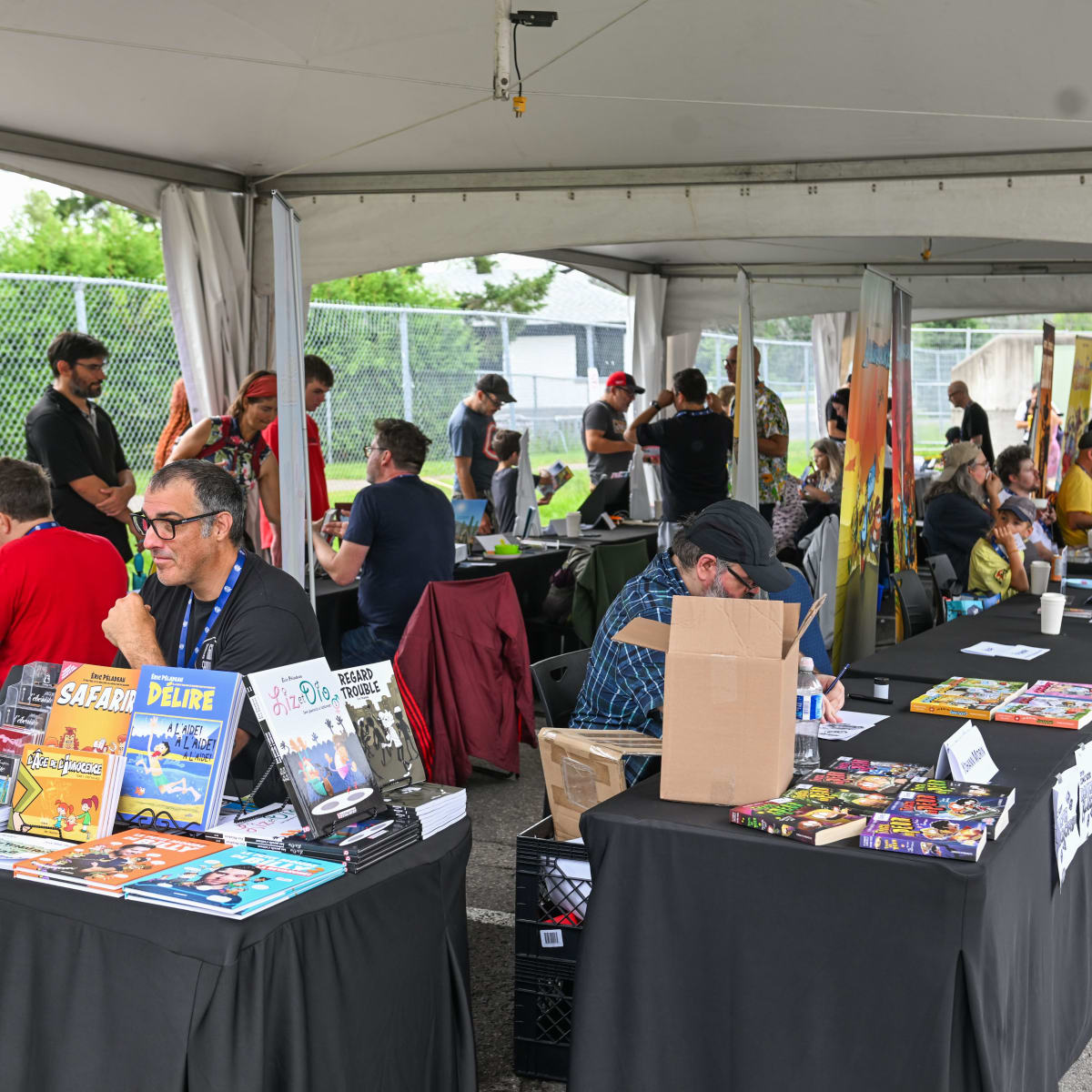 Prévost Comic Arts Festival - Cartoonists seated at tables to meet people