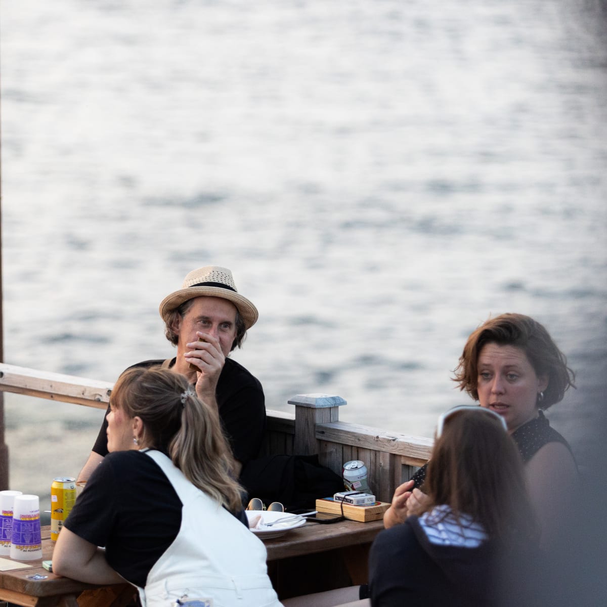 4 people on a patio next to the sea at Festival en chanson de Petite-Vallée.