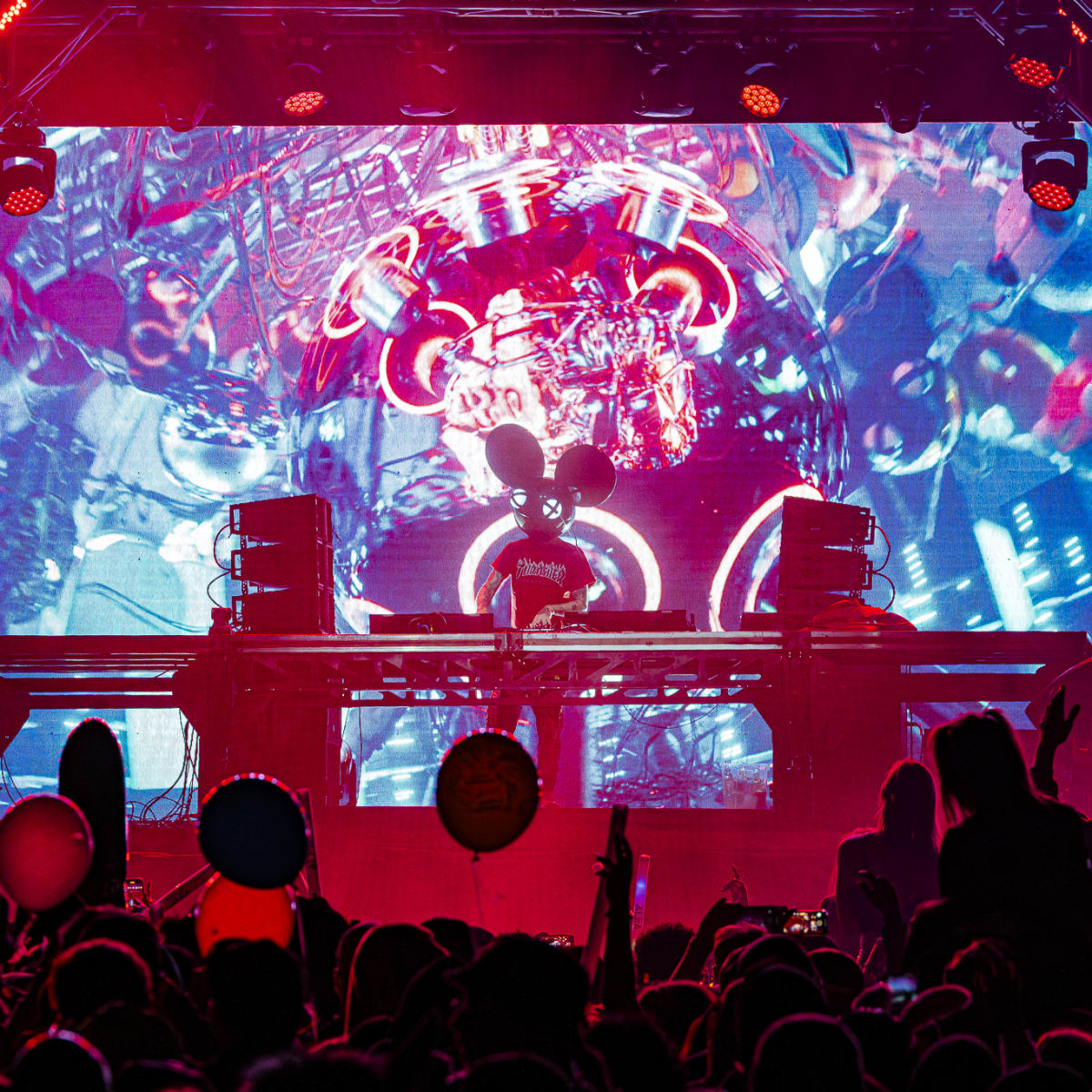 Riverside Festival - DJ on stage with colored lights behind.