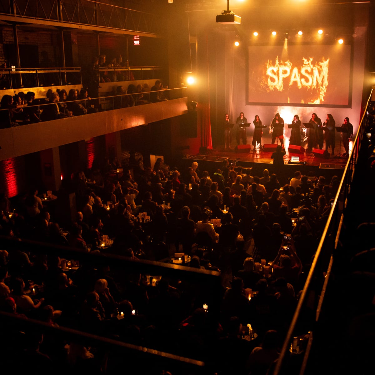 SPASM Festival -  Dark venue filled with spectators.