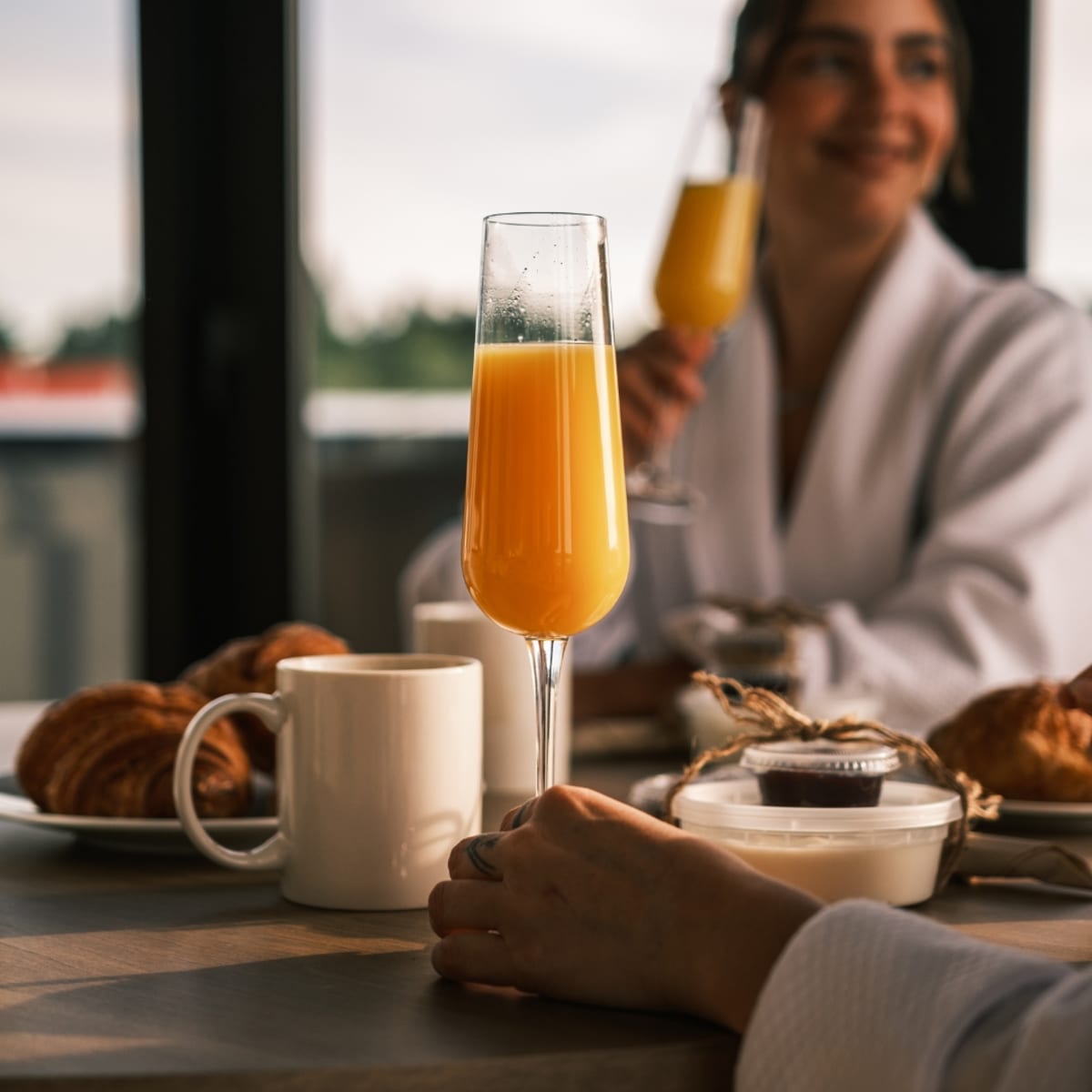 Two women having breakfast and mimosas.