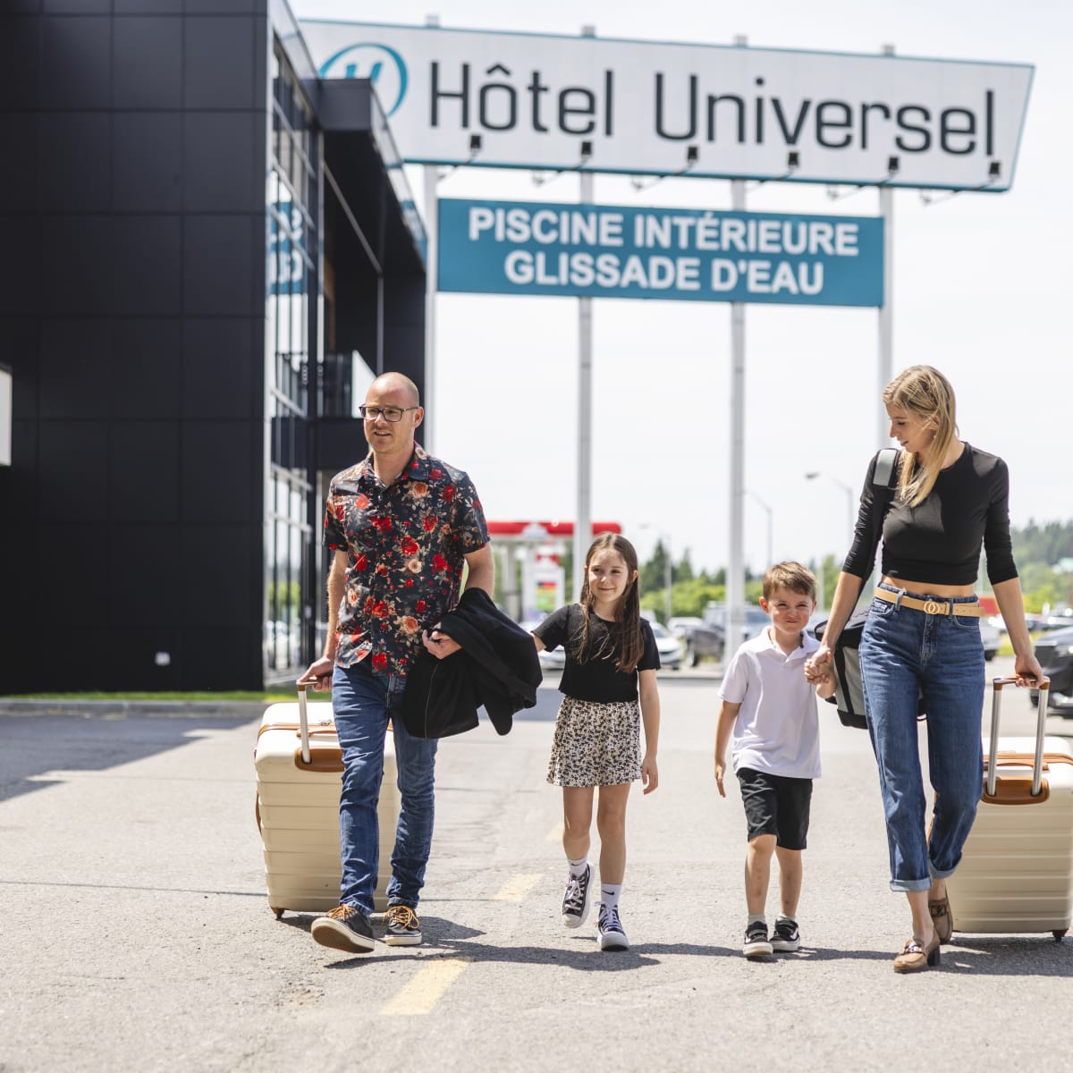 Hôtel Universel Rivière-du-Loup - Une famille marche avec leurs valises