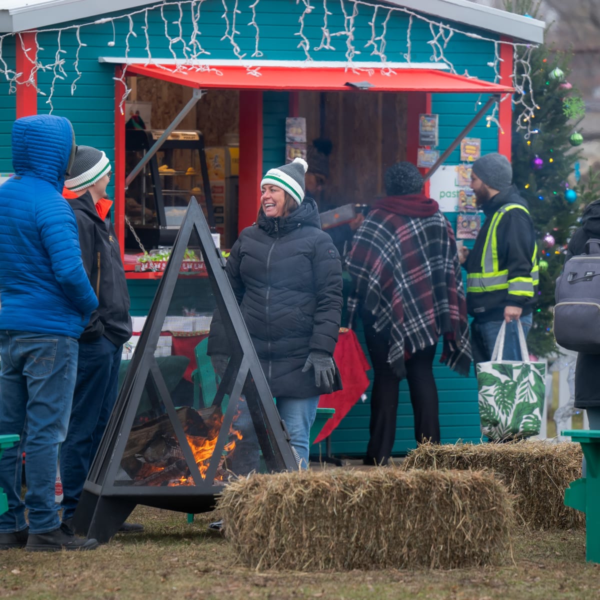 Des personnes discutent devant un feu de camp pour se réchauffer.