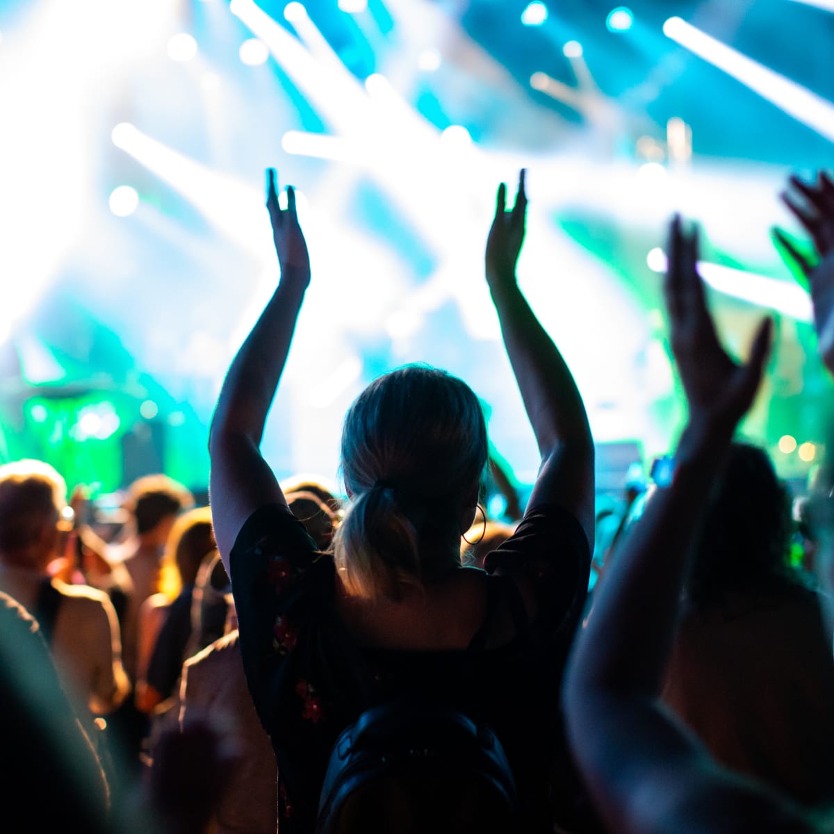 People clapping their hands at a festival