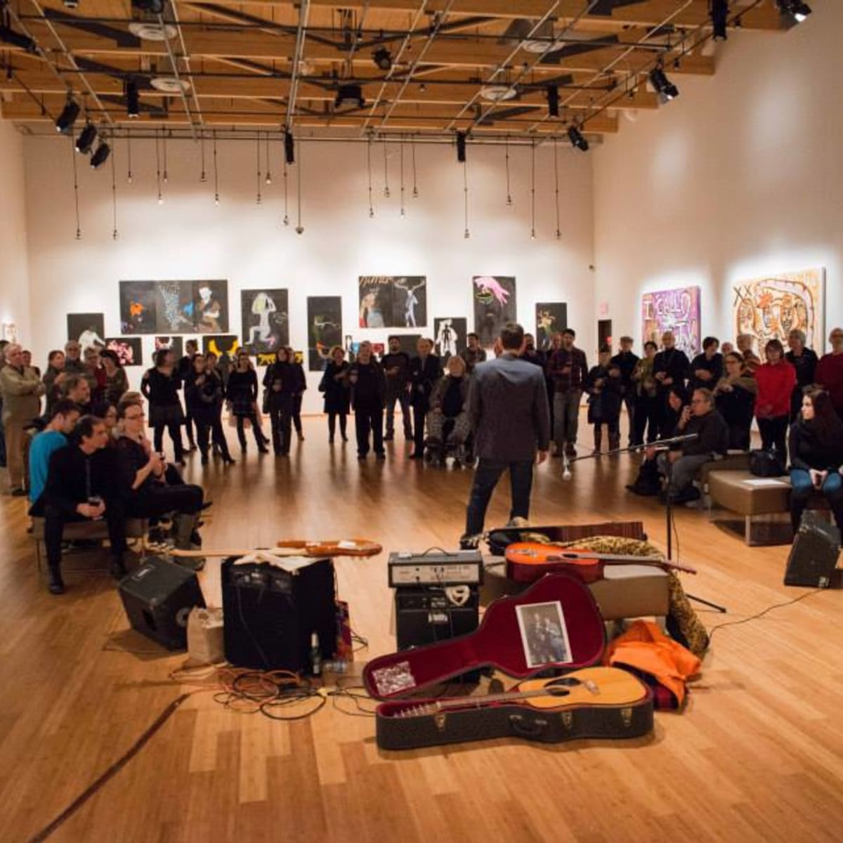 MA, Rouyn-Noranda Art Museum - A man is surrounded by people and instruments in a showroom