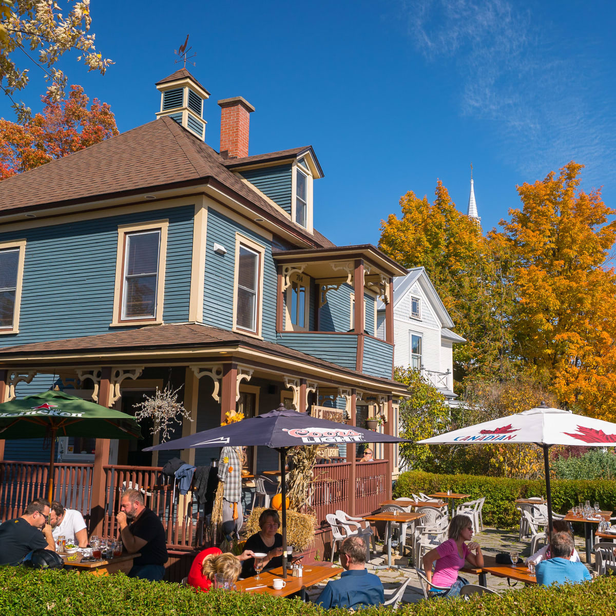 Customers eating on a restaurant patio in the fall.