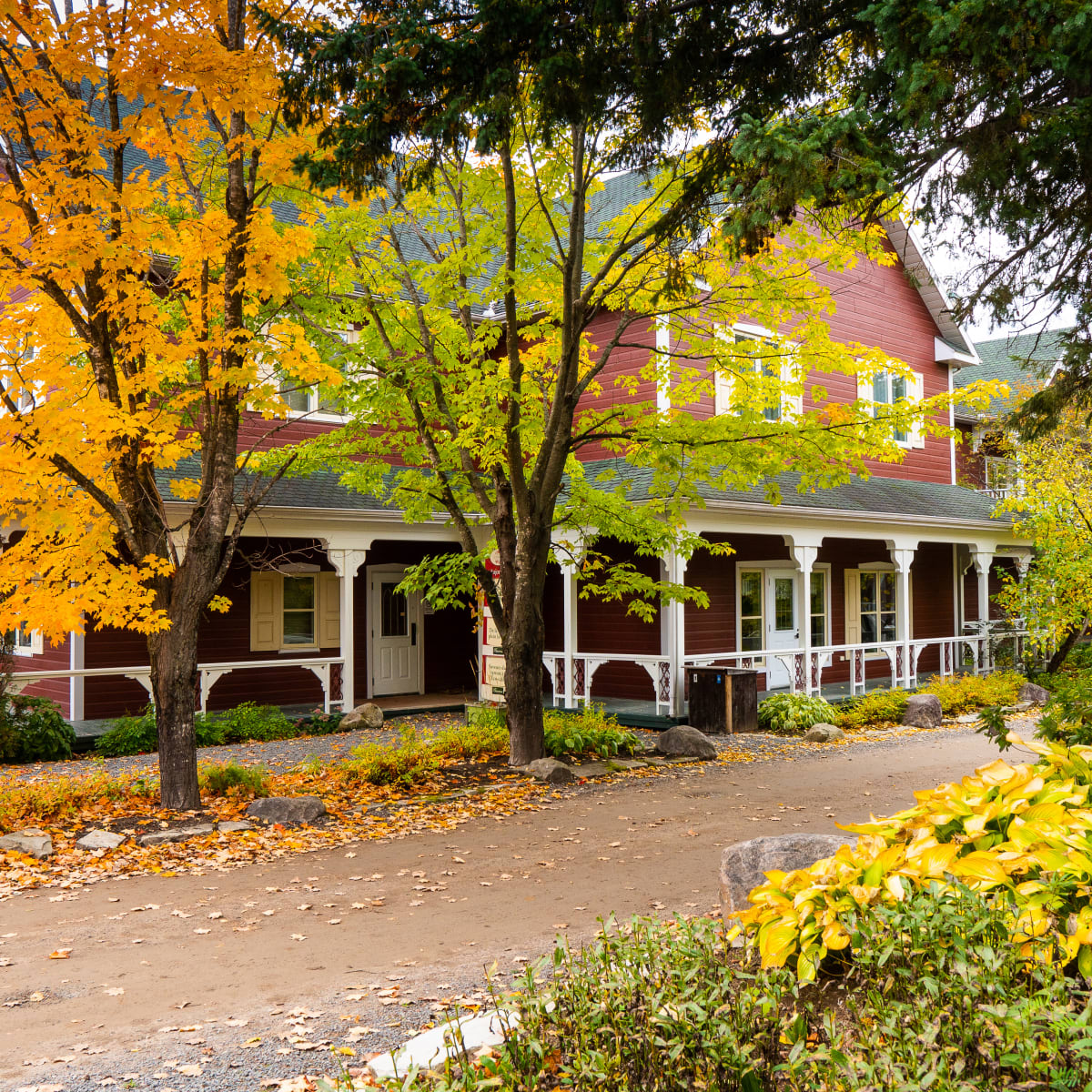 The main building of the Le Baluchon eco-resort in a fall setting.