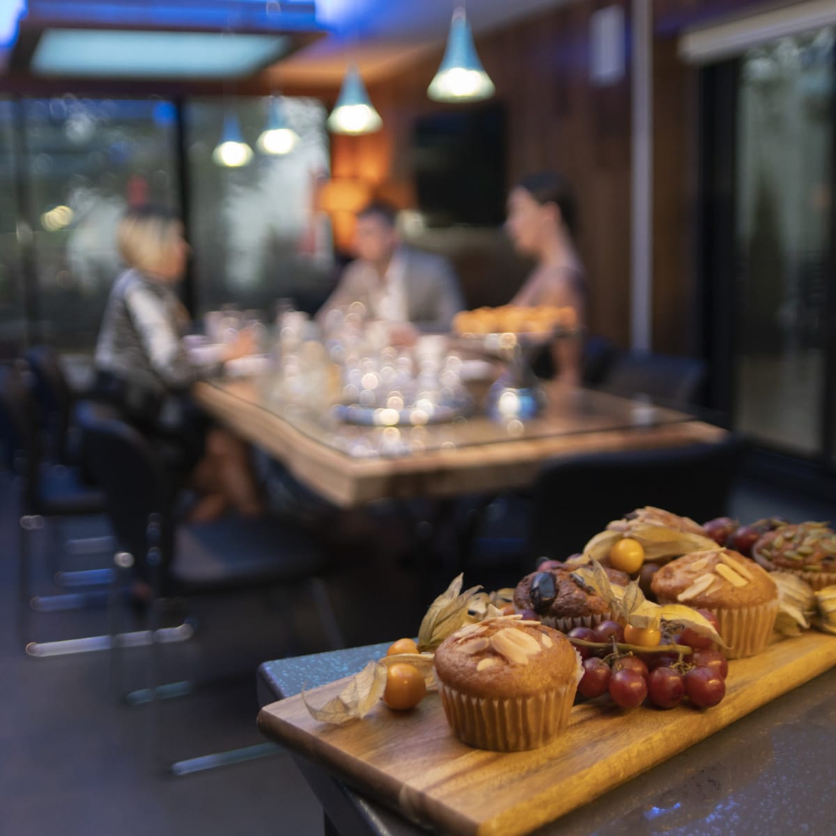 Breakfast board and table of people in a restaurant.