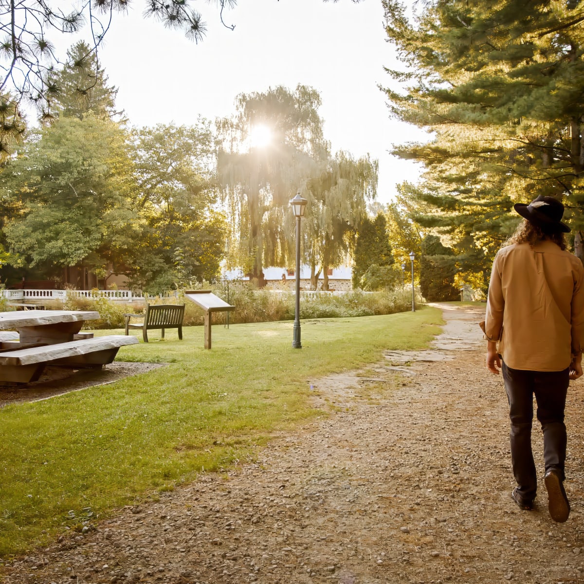 A person facing away from the camera, walking on the nature trails.