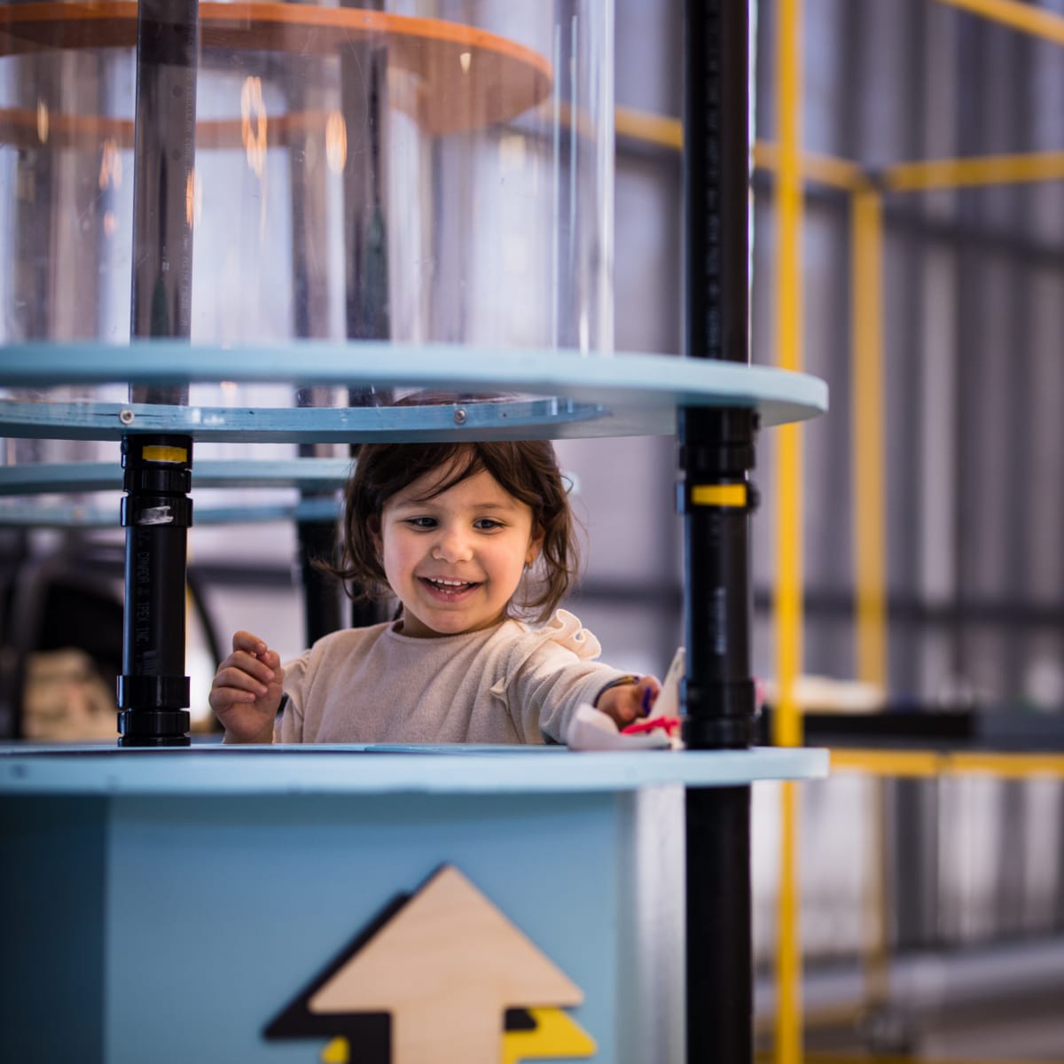 Little girl enjoying the tinkering challenges at the Bombardier Museum of Ingenuity.