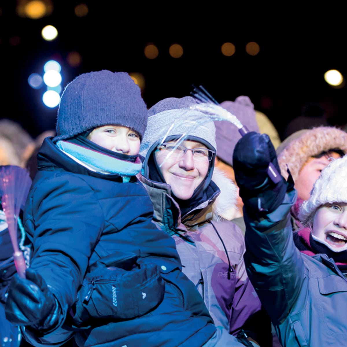 A mother and her children bundled up, ready to enjoy the celebrations.