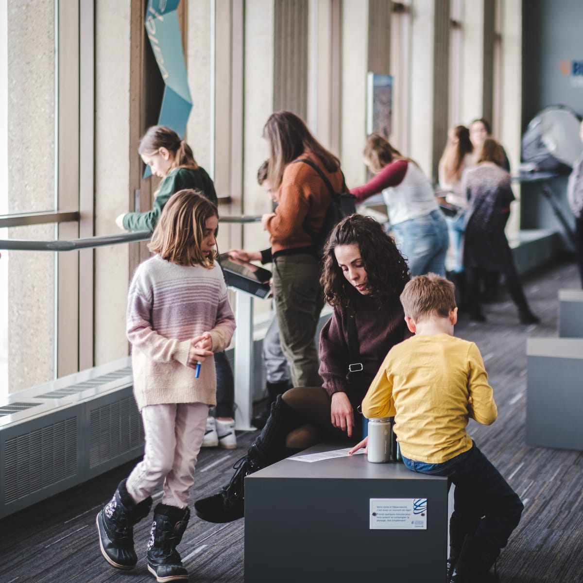 Parents and kids at the exhibit at the Québec City Observatory.
