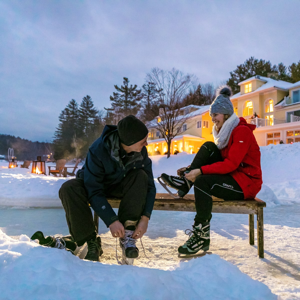 Couple at the skating rink at the Ripplecove lacing their skates.