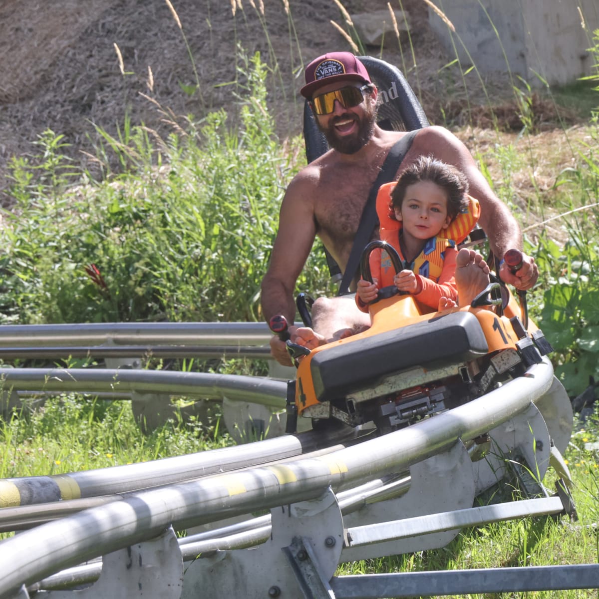 A father and son in the alpine rollercoaster.