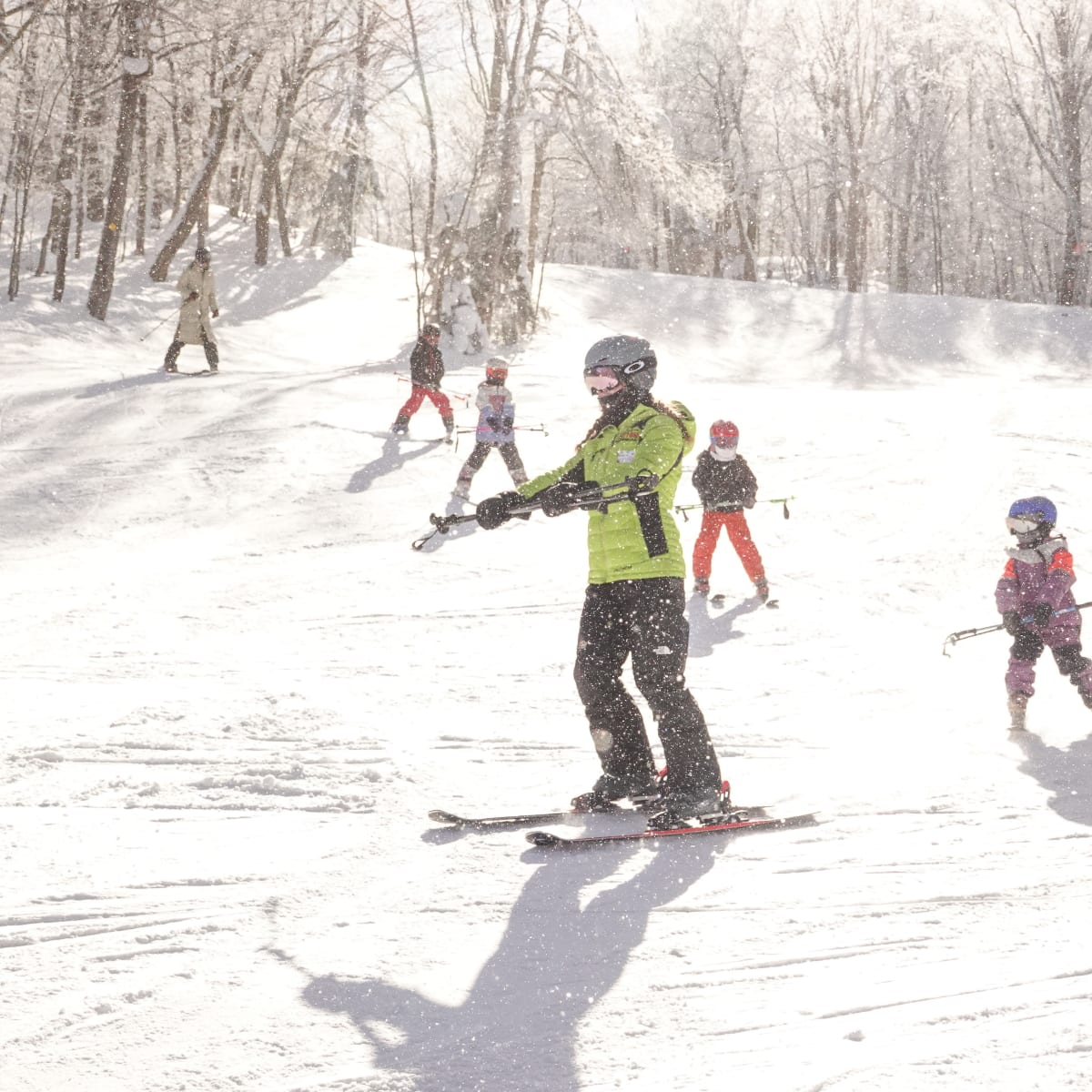 Ski instructor with students behind him.