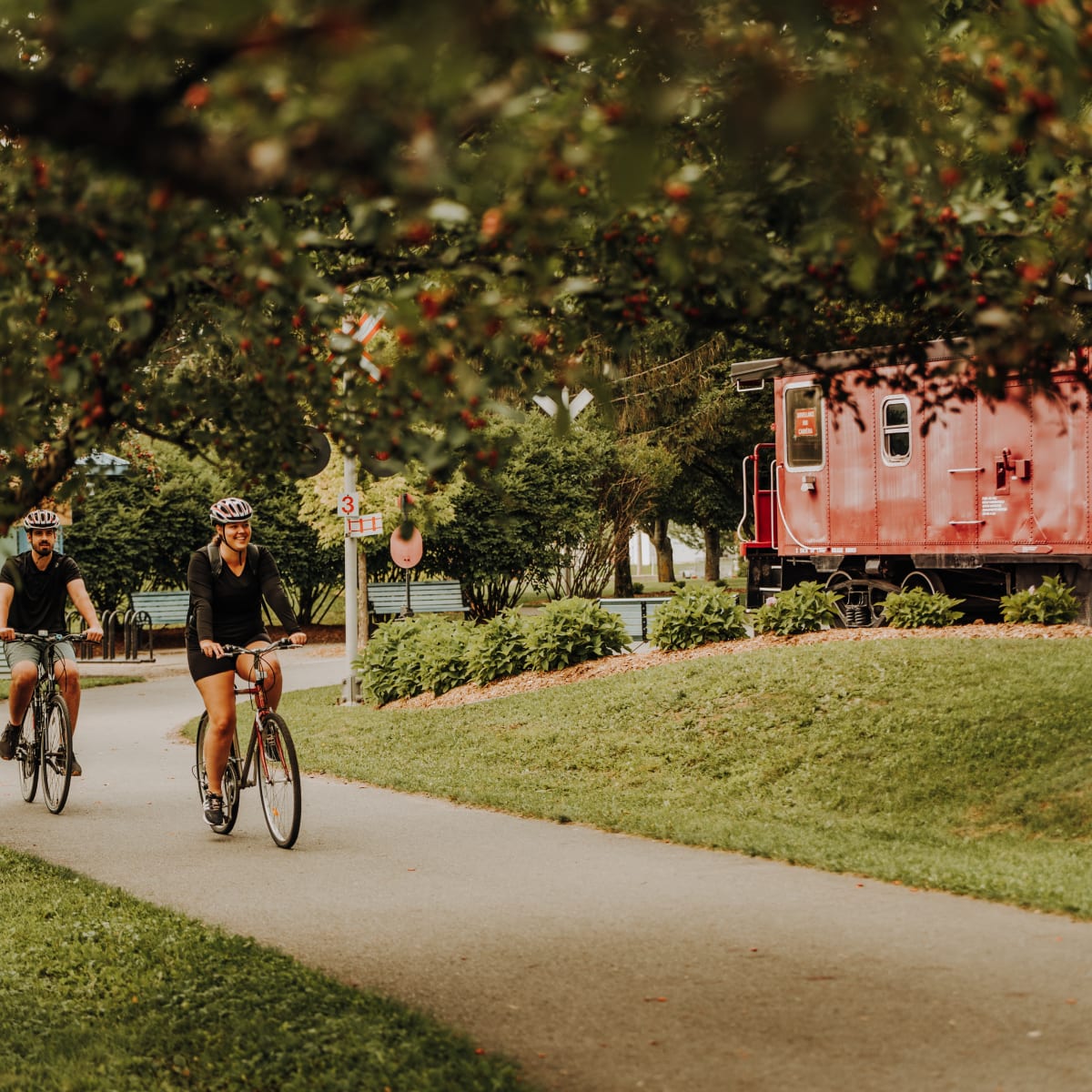 Couple on bicycles on a paved path.