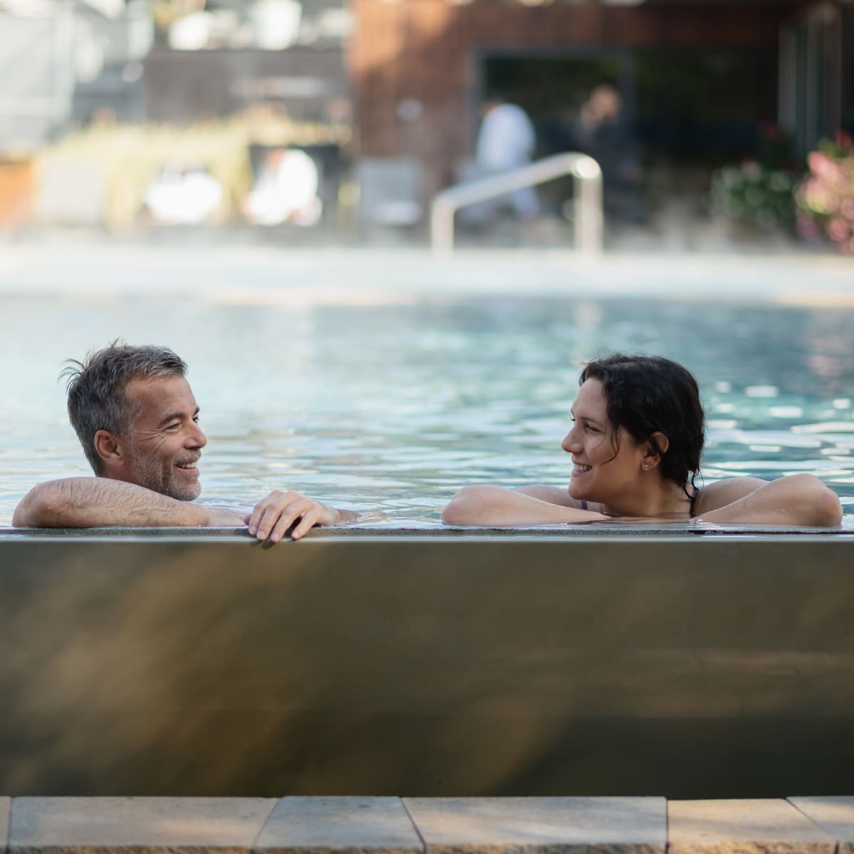 Two people soaking in a thermal pool.