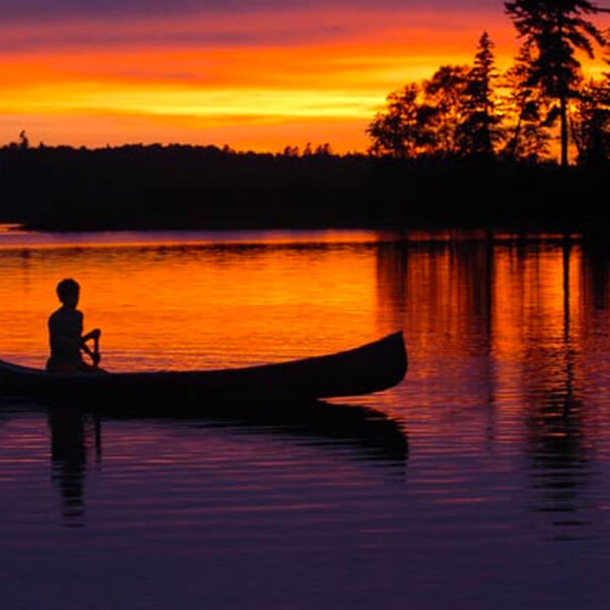 Fishing in a canoe at sunrise
