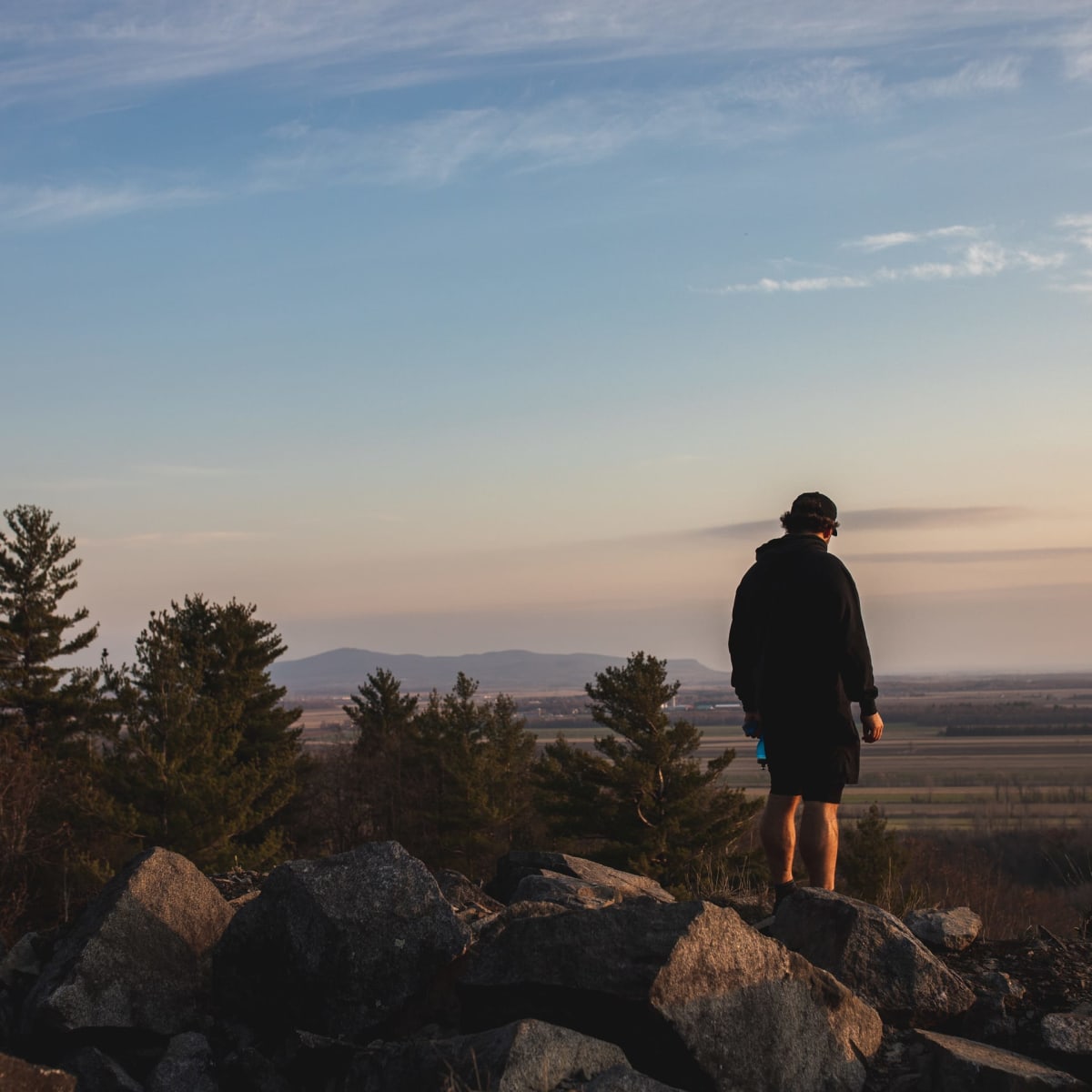 Man on top of a mountain in Haut-Richelieu.