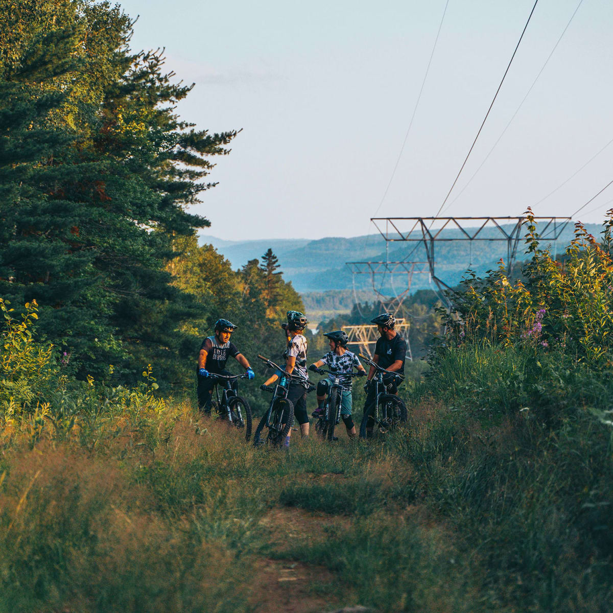 A group of cyclists at the top of a hill. 