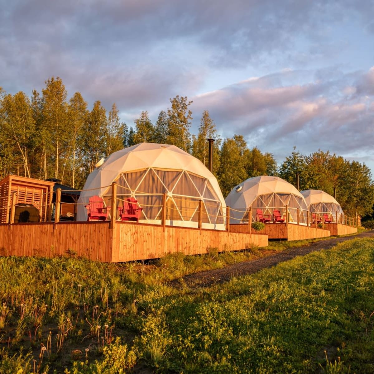 Three domes on a platform bathed in golden light.