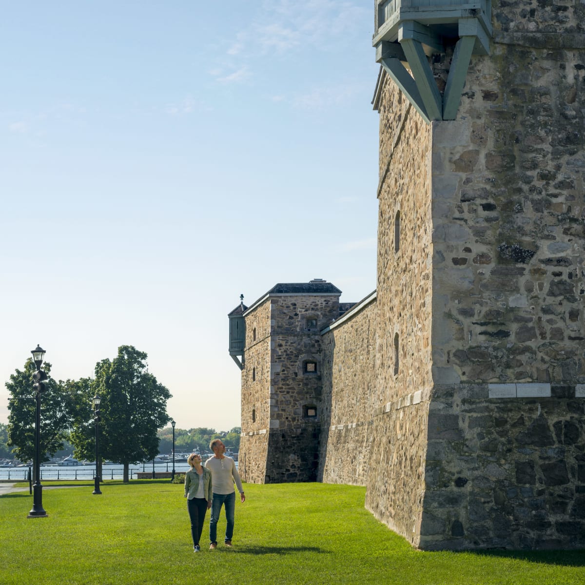 Two people walking near Fort Chambly.