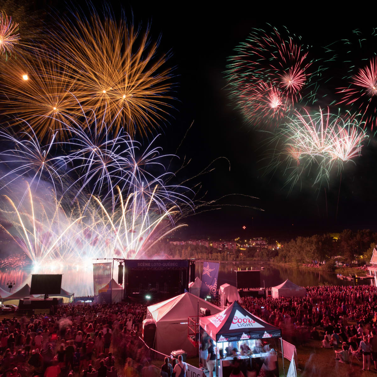Fireworks over a crowd gathered for the Fête du Lac des Nations.