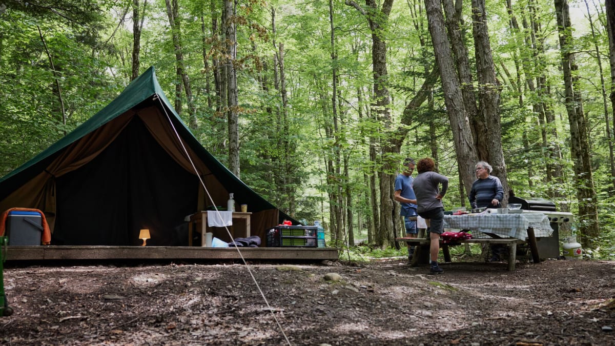 Canvas tents in the woods at Huttopia Sutton.