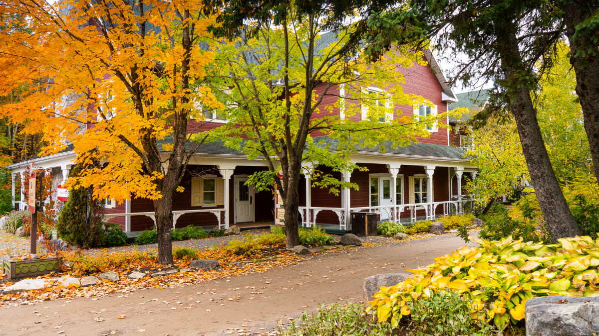 The main building of the Le Baluchon eco-resort in a fall setting.