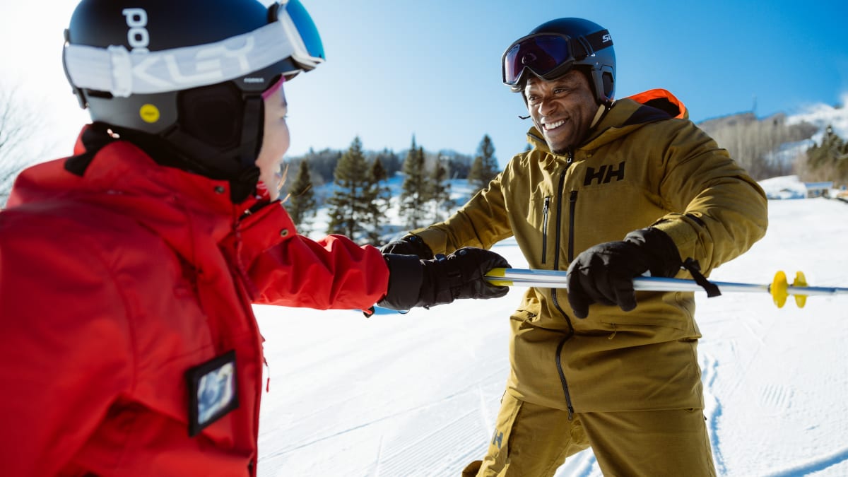 Smiling man learning how to ski.