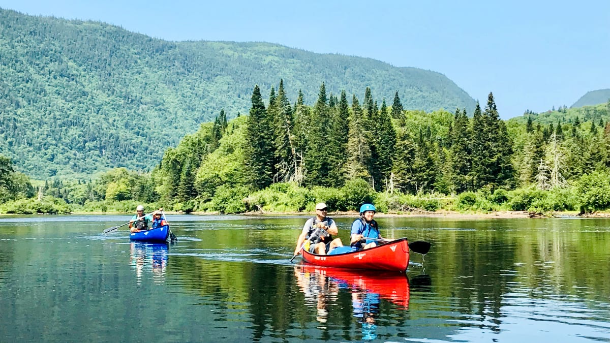 Two couples in two canoes on the lake.