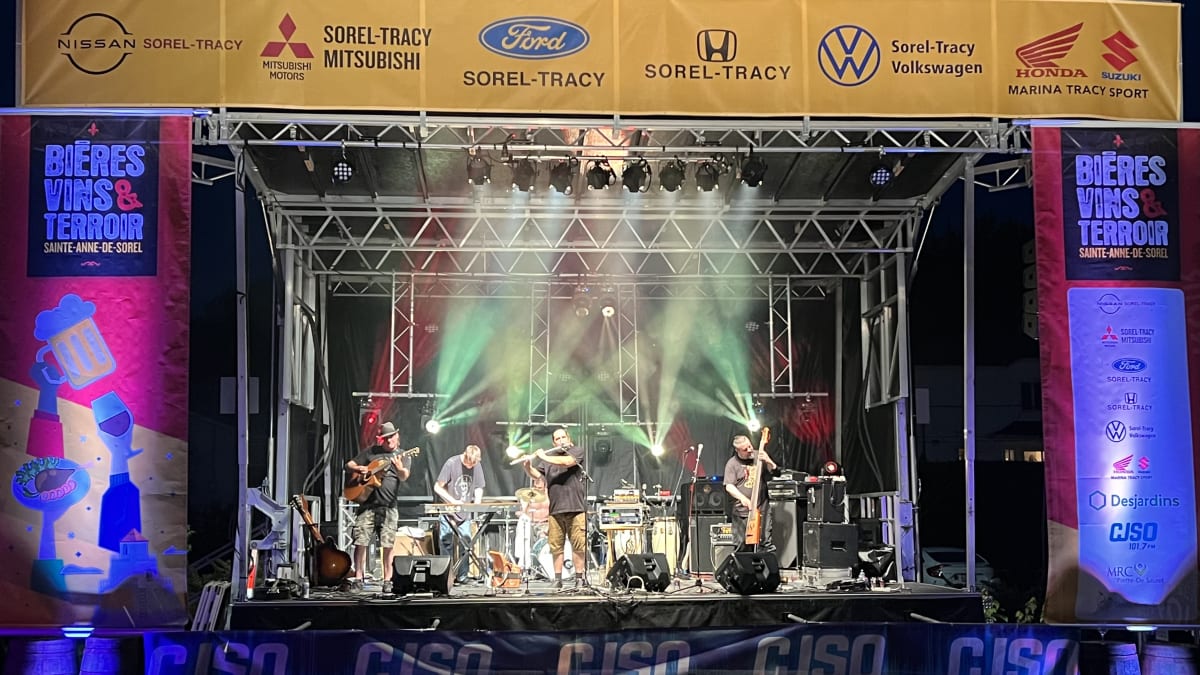 Groupe de musique rock de cinq personnes sur la scène.