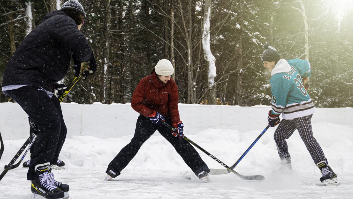Three men playing ice hockey.