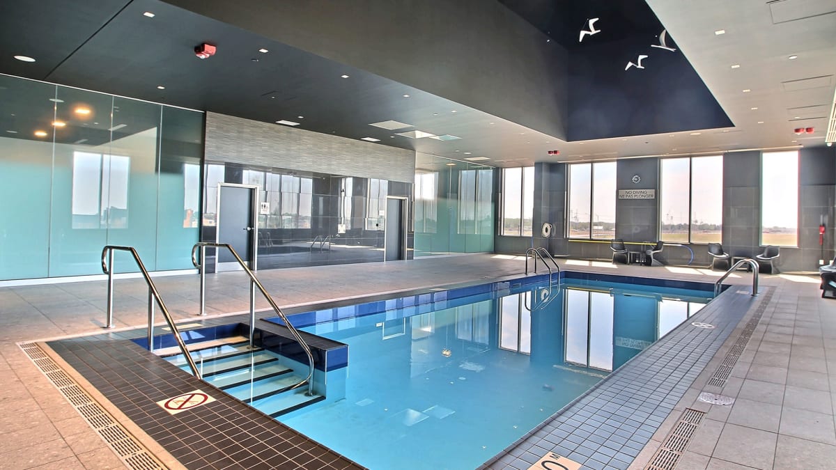 Piscine intérieure de l'hôtel dans une salle vitrée.