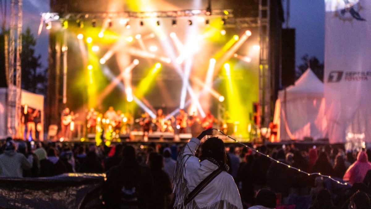 Stage with lights during a show in the late evening during the Innu Nikamu festival.
