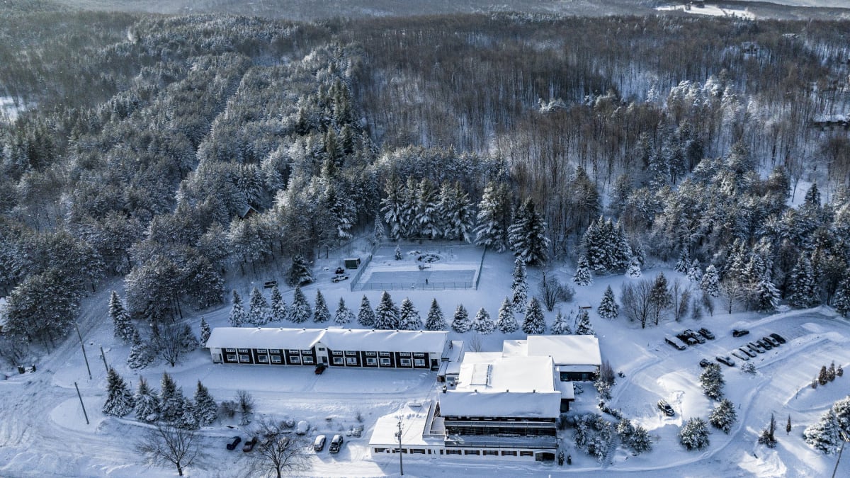 Aerial view of the Hotel Horizon and surrounding area covered in snow