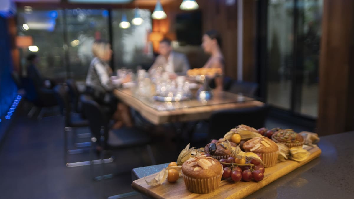 Breakfast board and table of people in a restaurant.