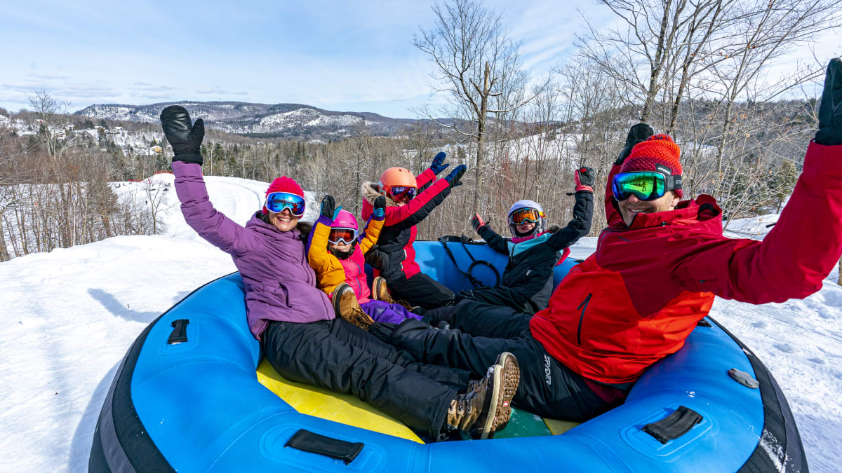 Happy family on a tube sliding slope.