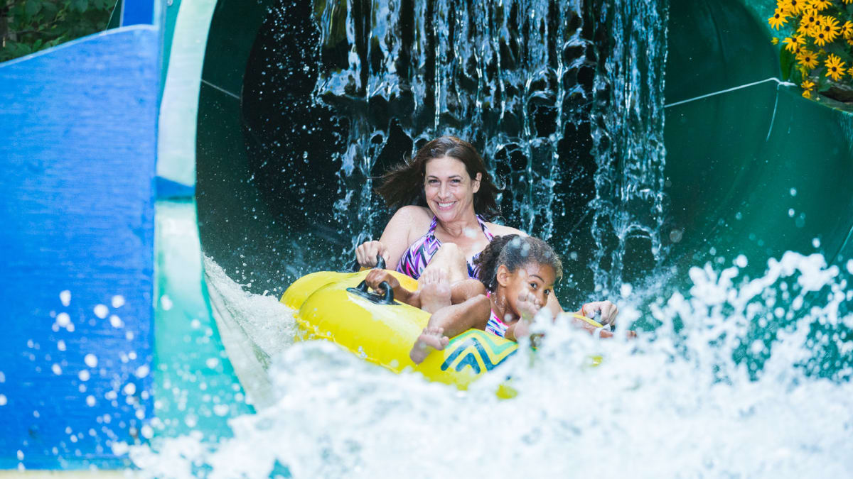 Mother and daughter on a water slide.