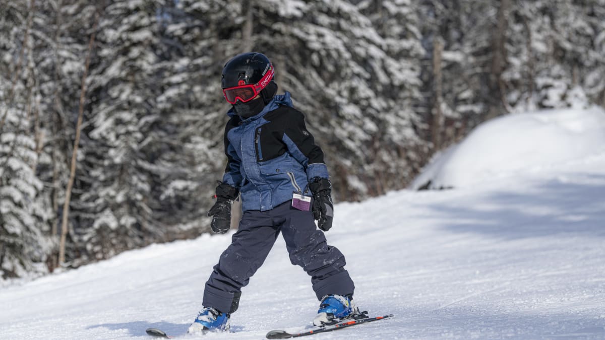 Enfant qui apprend à skier sur la pente.