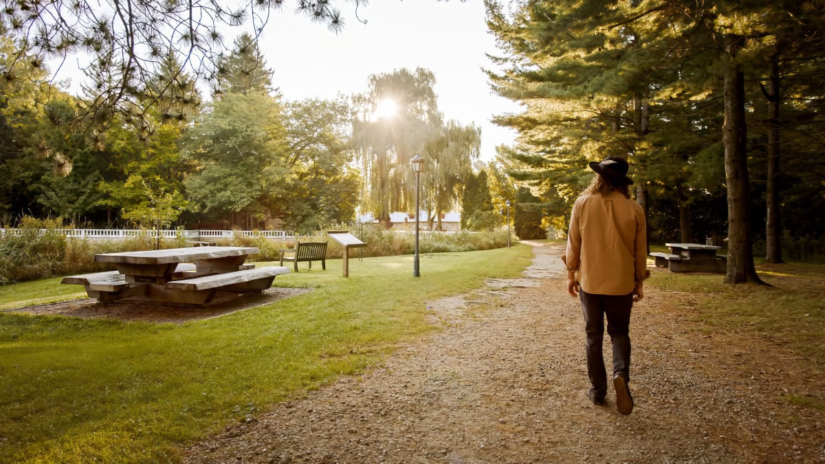 A person facing away from the camera, walking on the nature trails.