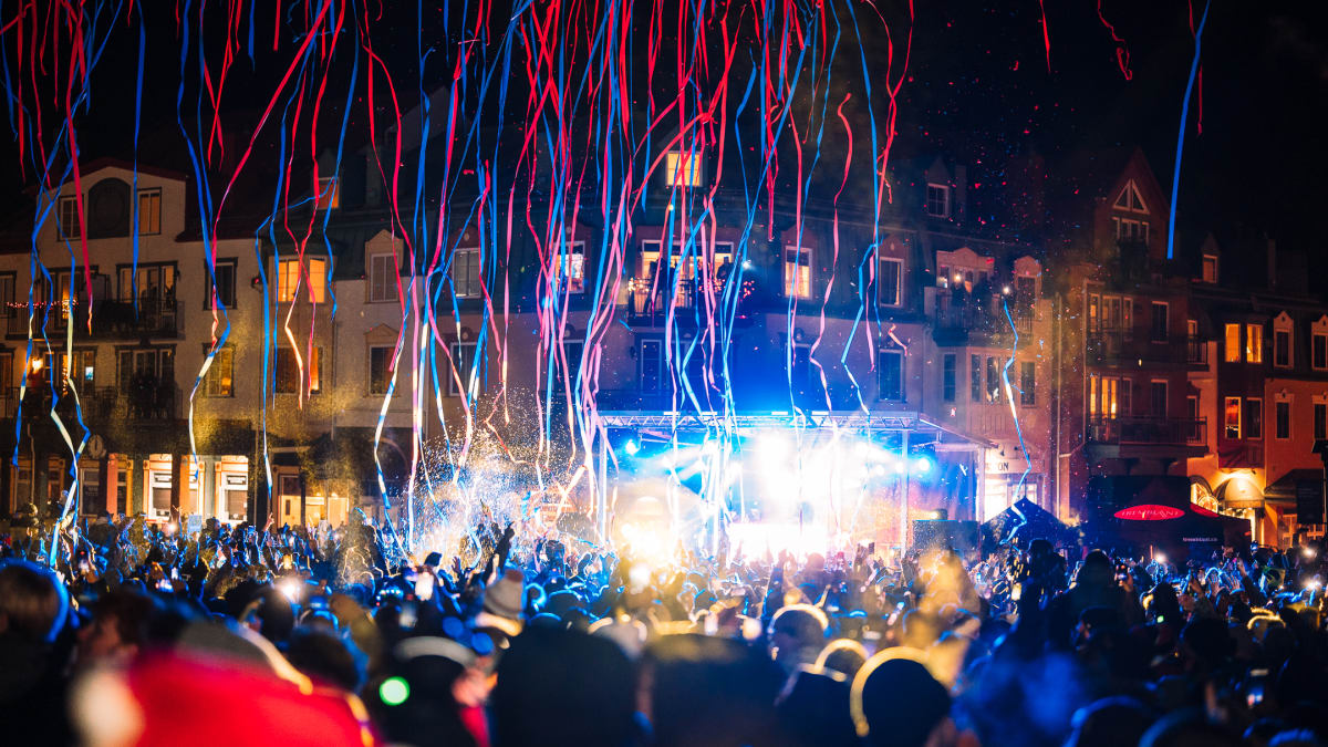 Confetti falling on a crowd gathered outdoors.