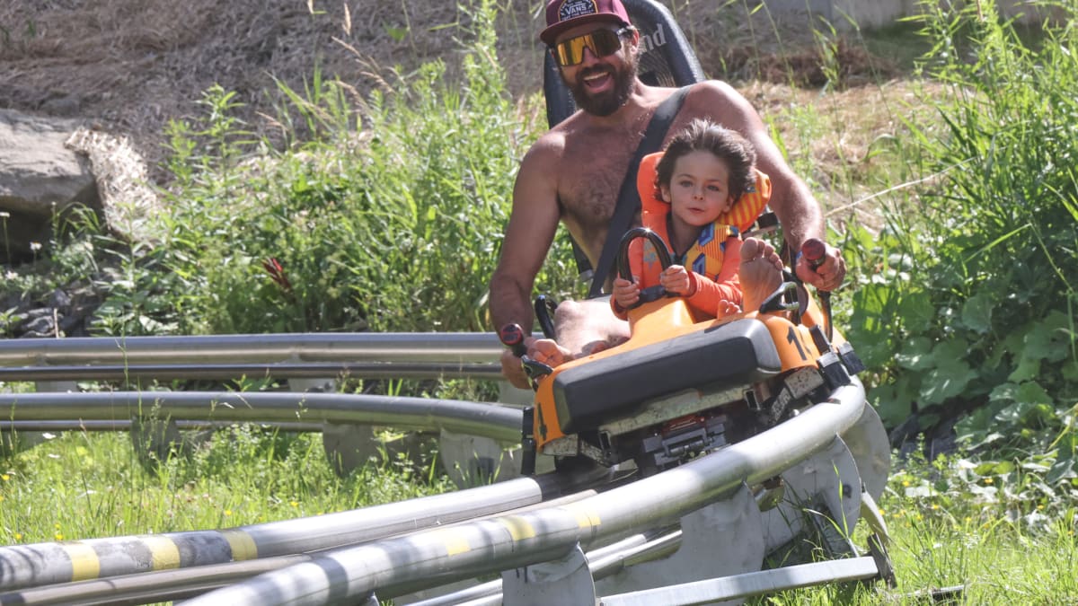 A father and son in the alpine rollercoaster.
