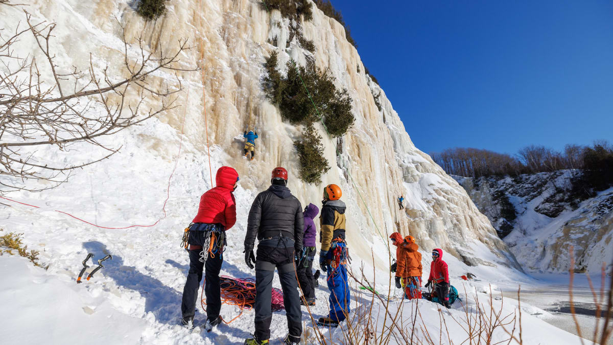 Groupe de personnes au pied d’une paroi glacée