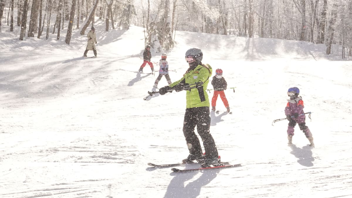 Ski instructor with students behind him.