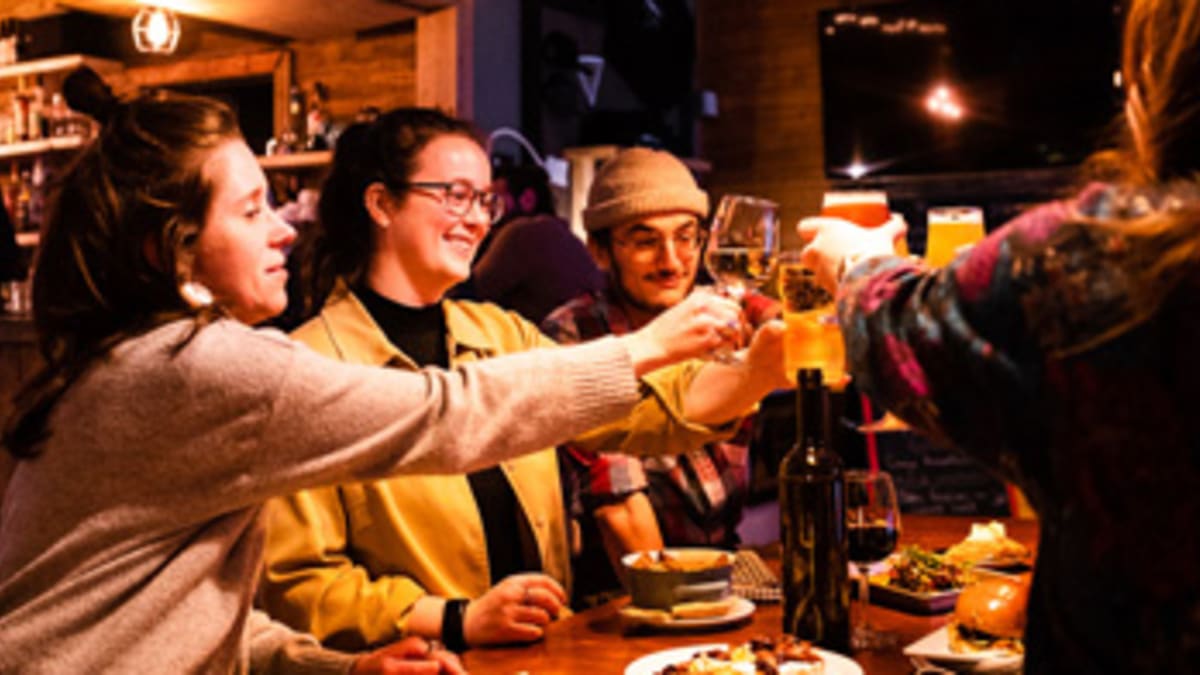 Group of friends making a toast around a table