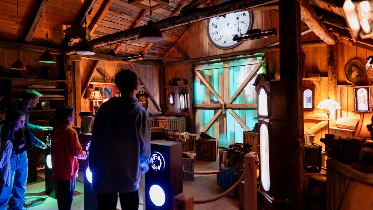 Family in the clock workshop at the Village Québécois d'Antan